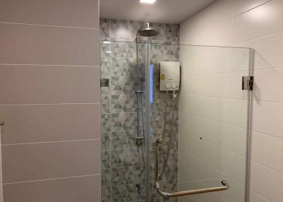 Modern bathroom with geometric tiles and glass shower enclosure