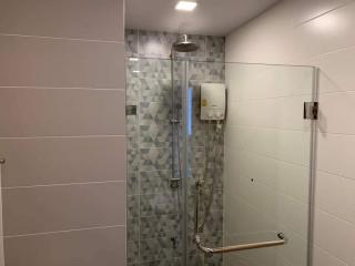 Modern bathroom with geometric tiles and glass shower enclosure