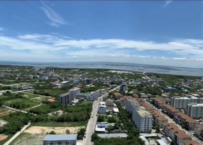 Panoramic aerial view of a suburban area showcasing residential and commercial buildings with clear skies