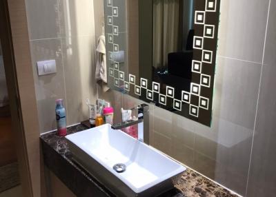 Modern bathroom with marble countertop and large mirror