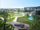 Lush outdoor communal space with a swimming pool and walking paths