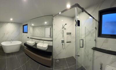 Modern spacious bathroom with double vanity and freestanding bathtub