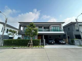 Modern two-story house with a garage and front lawn