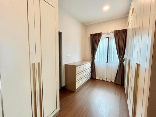 Spacious bedroom with large window and built-in closets