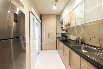 Modern kitchen with stainless steel appliances and wooden cabinets