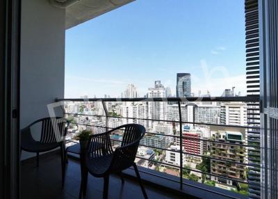 Spacious balcony with a city view featuring seating arrangements