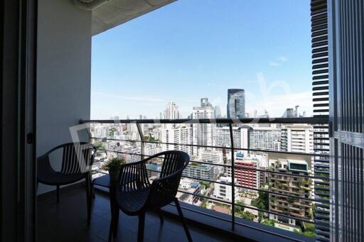 Spacious balcony with a city view featuring seating arrangements