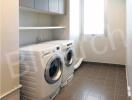 Compact laundry room with modern appliances and ample storage