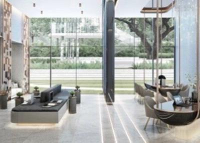 Modern open-plan lobby area with seating and expansive glass windows