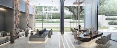 Modern open-plan lobby area with seating and expansive glass windows