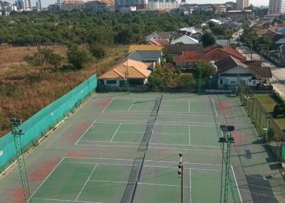 Tennis courts with a cityscape in the background