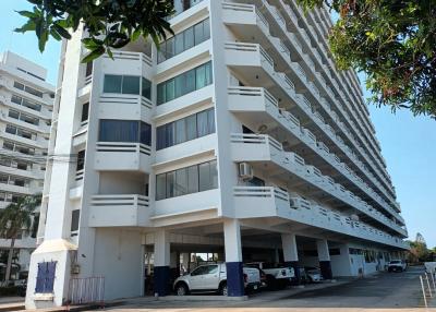 Exterior view of a modern apartment building with parking space