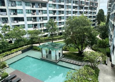 Apartment complex with swimming pool and lounge chairs