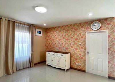 Spacious and brightly lit building interior with patterned wallpaper and tiled flooring