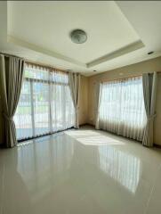 Spacious living room with large windows and natural light