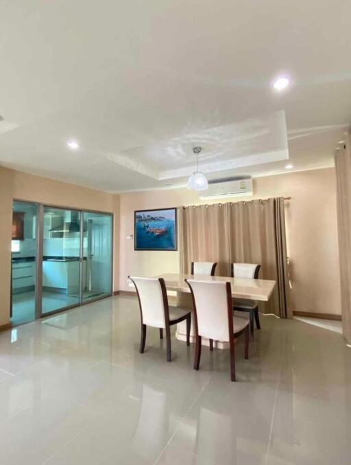 Spacious dining room with modern lighting and tiled flooring