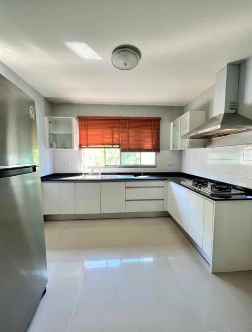 Modern kitchen with white cabinetry and natural light