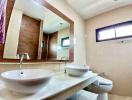 Modern bathroom interior with dual sink vanity and large mirror