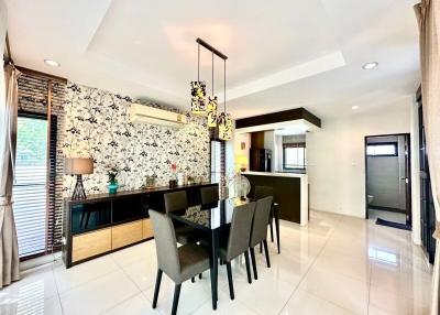 Modern dining room with decorative wallpaper and tiled flooring