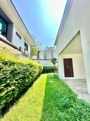 Bright and well-maintained house exterior with a green lawn