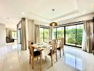 Spacious modern dining room with large windows and garden view