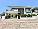 Modern two-story house with balcony and garage