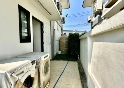 Covered outdoor laundry space between residential buildings