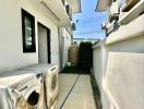 Covered outdoor laundry space between residential buildings