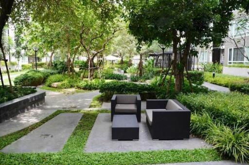 Modern outdoor seating in a lush garden common area