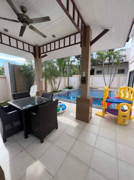 Spacious patio with outdoor furniture and pool