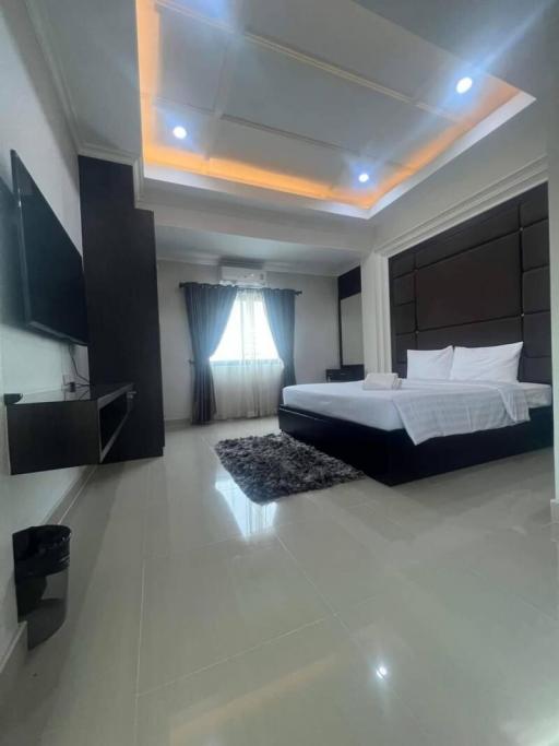 Modern bedroom with ambient lighting and contemporary furniture.