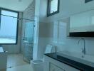 Modern bathroom interior with glass shower and city view