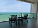 Spacious balcony with ocean view featuring a dining set