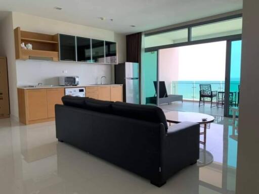 Modern living room with open kitchen and ocean view