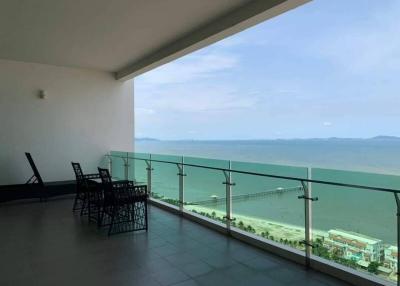 Spacious balcony with a sea view and outdoor sitting area
