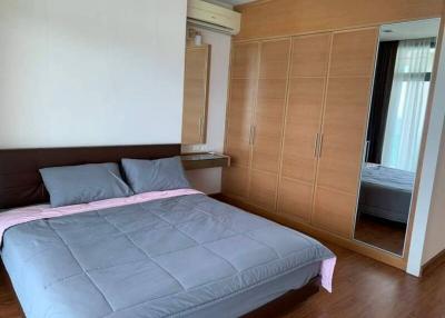 Spacious bedroom with large bed and built-in wardrobe