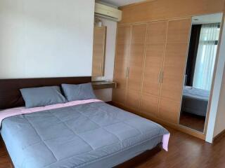 Spacious bedroom with large bed and built-in wardrobe