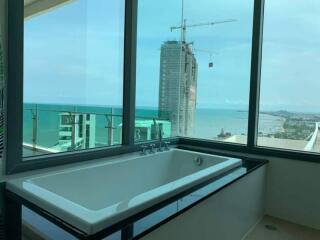 Modern bathroom with large window and ocean view