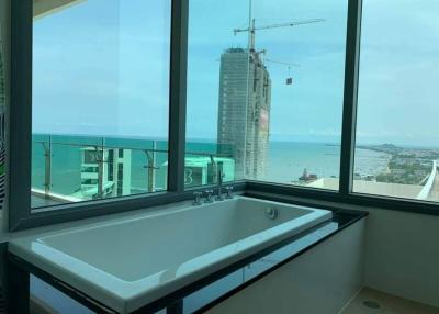 Modern bathroom with large window and ocean view