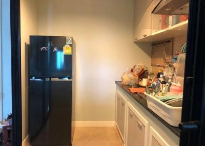 Compact kitchen with modern refrigerator and ample counter space