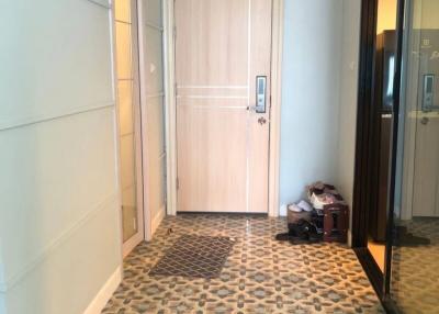 Bright entrance hall with patterned floor and white door