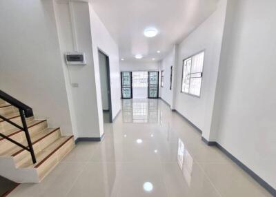 Bright and modern corridor with reflective flooring and natural light