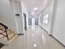 Bright and modern corridor with reflective flooring and natural light