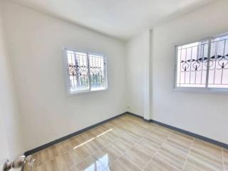 Bright bedroom with tiled flooring and large windows