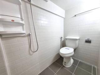 Modern bathroom with white tiled walls and shower