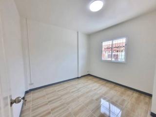Empty bedroom with tiled flooring and ample natural light
