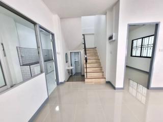 Spacious hallway with staircase and tiled flooring