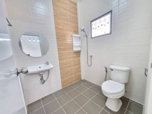 Modern bathroom with white tiles and natural light