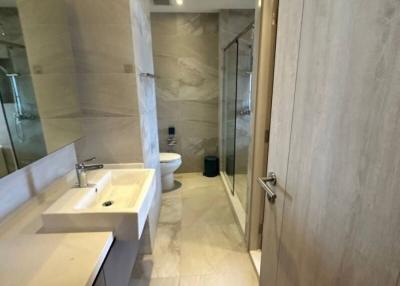 Modern bathroom interior with glass shower and marble tiles