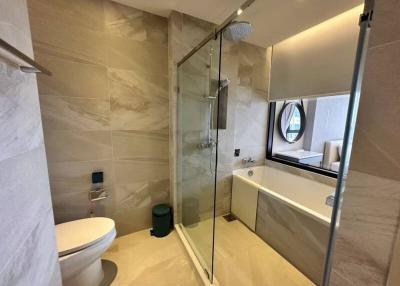 Modern bathroom with neutral tiles and glass shower